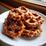 A stack of crunchy pretzels generously coated in glossy caramel and sprinkled with coarse sea salt, our ultimate toffee pretzels.