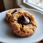 Close-up of two delicious, sugar-coated peanut butter kiss cookies topped with melted chocolate.