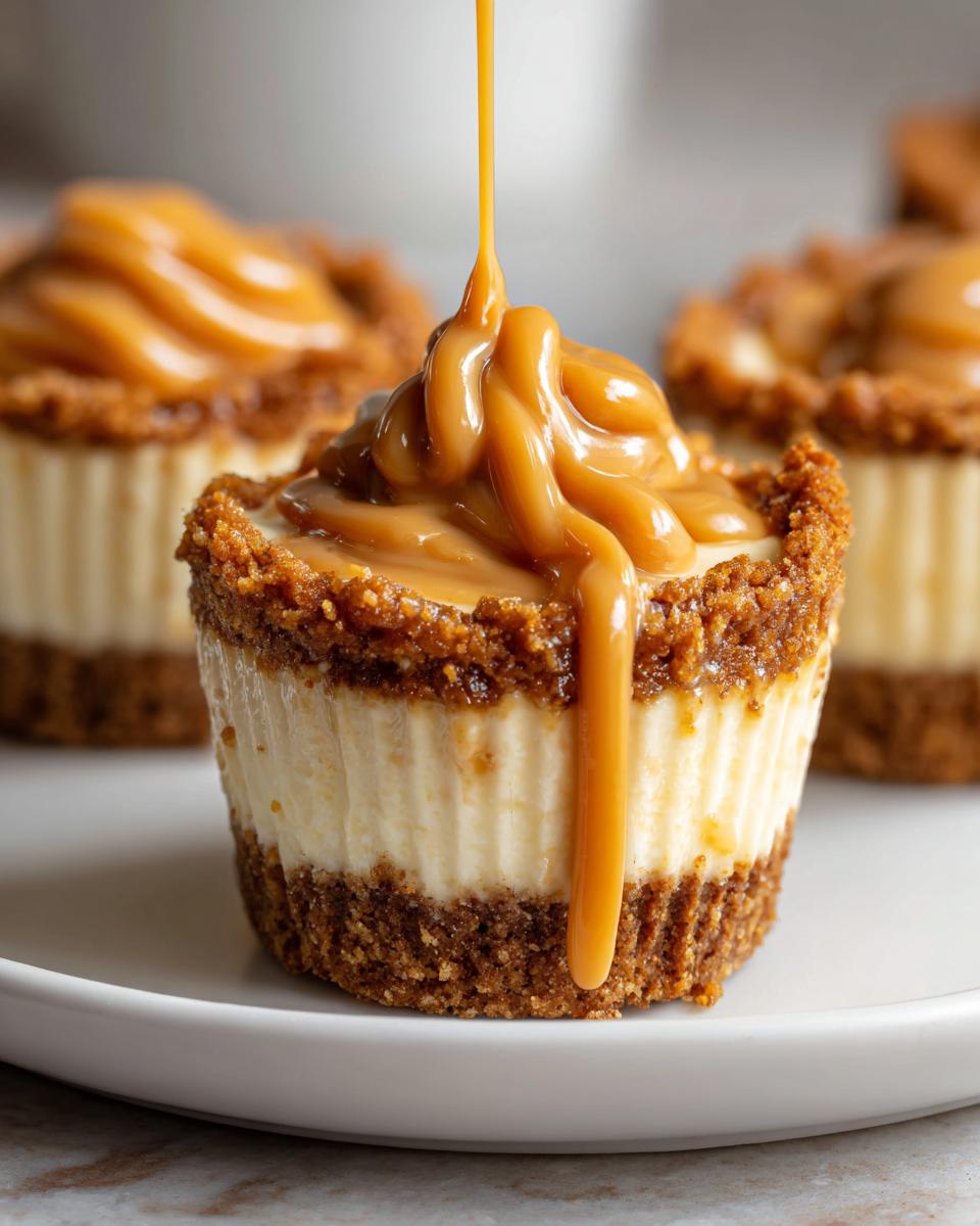 Close-up of a cookie butter cheesecake cup being drizzled with thick caramel sauce.
